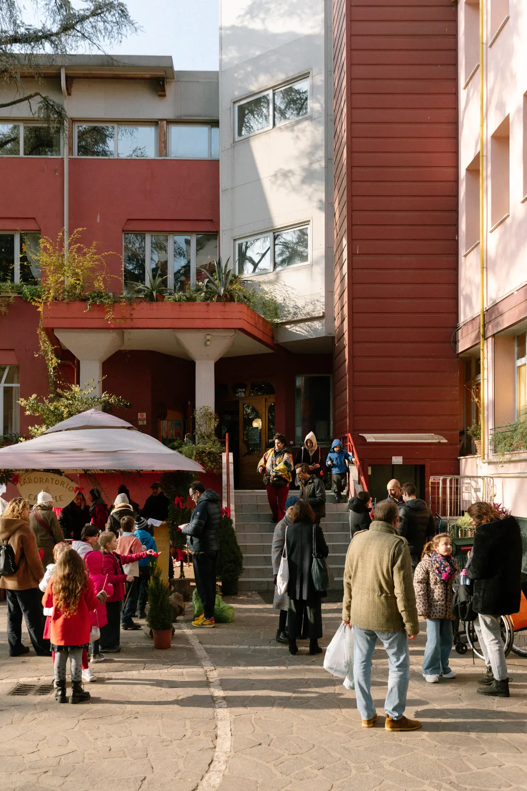 Famiglie e bambini nel cortile della scuola durante il bazar